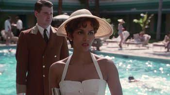 Movie still from “Introducing Dorothy Dandridge” (1999), directed by Martha Coolidge – A woman in a white dress and a straw hat; Medium shot, Over the shoulder angle