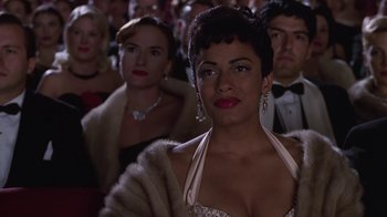 Movie still from “Introducing Dorothy Dandridge” (1999), directed by Martha Coolidge – A group of people sitting in front of each other; Close Up shot, Over the shoulder angle