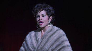 Movie still from “Introducing Dorothy Dandridge” (1999), directed by Martha Coolidge – A woman in a white fur coat and big earrings; Close Up shot, High angle