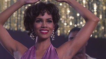 Movie still from “Introducing Dorothy Dandridge” (1999), directed by Martha Coolidge – A woman in a purple dress is posing for the camera; Close Up shot, Low angle