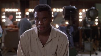 Movie still from “Introducing Dorothy Dandridge” (1999), directed by Martha Coolidge – A man in a tan shirt is in front of a camera; Close Up shot, Over the shoulder angle