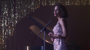 Movie still from “Introducing Dorothy Dandridge” (1999), directed by Martha Coolidge – A woman standing at a microphone in front of a stage; Medium shot, Over the shoulder angle