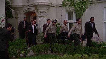 A group of men walking down a sidewalk