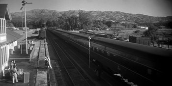 Movie still from “Invasion of the Body Snatchers” (1956), directed by Don Siegel – Black and white photograph of train tracks near mountains; Extreme Wide shot, Low angle