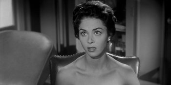 Movie still from “Invasion of the Body Snatchers” (1956), directed by Don Siegel – A black - and - white photo of a woman looking at the camera; Close Up shot, Over the shoulder angle