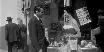 Movie still from “Invasion of the Body Snatchers” (1956), directed by Don Siegel – A man and a woman standing next to each other; Medium shot, Over the shoulder angle