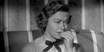Movie still from “Invasion of the Body Snatchers” (1956), directed by Don Siegel – An old photo of a woman in a bow tie; Close Up shot, High angle