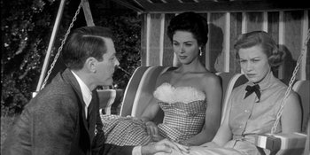 Movie still from “Invasion of the Body Snatchers” (1956), directed by Don Siegel – A man and a woman are sitting on a couch together; Medium shot, Low angle