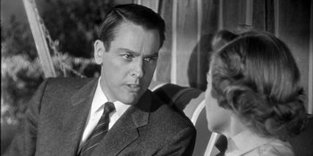 Movie still from “Invasion of the Body Snatchers” (1956), directed by Don Siegel – A black and white photo of a man and a woman; Close Up shot, Over the shoulder angle