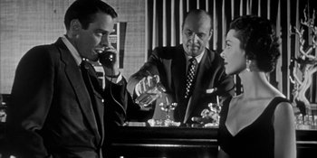 Movie still from “Invasion of the Body Snatchers” (1956), directed by Don Siegel – A man and a woman sitting at a table with another man; Medium shot, Over the shoulder angle