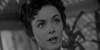 Movie still from “Invasion of the Body Snatchers” (1956), directed by Don Siegel – A woman's face in a black and white photo; Close Up shot, Low angle