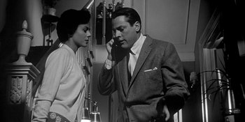 Movie still from “Invasion of the Body Snatchers” (1956), directed by Don Siegel – A man and a woman standing next to each other; Medium shot, Low angle