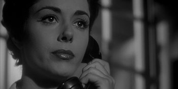 Movie still from “Invasion of the Body Snatchers” (1956), directed by Don Siegel – A black and white photo of a woman talking on a phone; Close Up shot, High angle