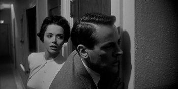 Movie still from “Invasion of the Body Snatchers” (1956), directed by Don Siegel – A man and a woman standing next to each other; Close Up shot, Low angle