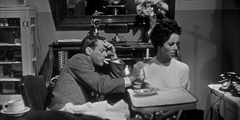 Movie still from “Invasion of the Body Snatchers” (1956), directed by Don Siegel – A man and a woman sitting at a dinner table; Medium shot, High angle
