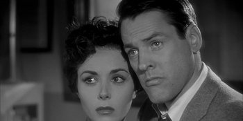 Movie still from “Invasion of the Body Snatchers” (1956), directed by Don Siegel – A man and a woman posing for a picture; Close Up shot, Low angle