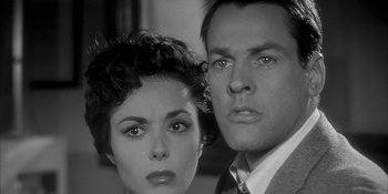 Movie still from “Invasion of the Body Snatchers” (1956), directed by Don Siegel – A man and a woman standing next to each other; Close Up shot, Low angle