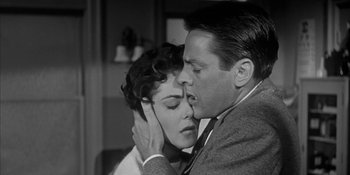 Movie still from “Invasion of the Body Snatchers” (1956), directed by Don Siegel – A man and a woman kissing in a black and white photo; Close Up shot, Low angle