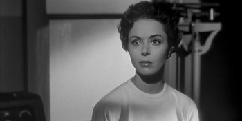 Movie still from “Invasion of the Body Snatchers” (1956), directed by Don Siegel – A black - and - white photo of a woman crying; Close Up shot, Over the shoulder angle