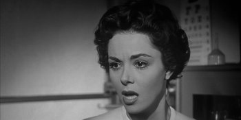 Movie still from “Invasion of the Body Snatchers” (1956), directed by Don Siegel – An old photo of a woman looking surprised; Close Up shot, Low angle