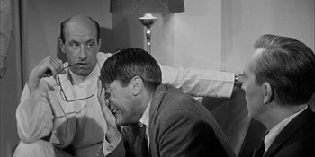 Movie still from “Invasion of the Body Snatchers” (1956), directed by Don Siegel – Two men sitting in front of each other; Close Up shot, Over the shoulder angle