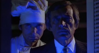 Movie still from “Invasion of the Body Snatchers” (1978), directed by Philip Kaufman – A man and a woman wearing chef's hats and a suit; Close Up shot, Low angle