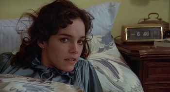 Movie still from “Invasion of the Body Snatchers” (1978), directed by Philip Kaufman – A woman sitting on top of a bed next to pillows; Close Up shot, Over the shoulder angle