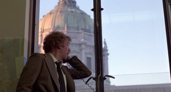 Movie still from “Invasion of the Body Snatchers” (1978), directed by Philip Kaufman – A man in a suit and tie talking on a phone; Medium shot, Low angle