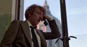Movie still from “Invasion of the Body Snatchers” (1978), directed by Philip Kaufman – A man wearing a suit and tie talking on a phone; Close Up shot, Low angle
