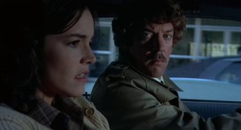 Movie still from “Invasion of the Body Snatchers” (1978), directed by Philip Kaufman – A man and a woman sitting in a car looking at each other; Close Up shot, Over the shoulder angle