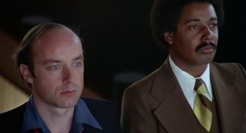 Movie still from “Invasion of the Body Snatchers” (1978), directed by Philip Kaufman – A man and a man in a suit and tie; Close Up shot, Low angle