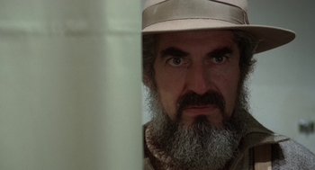 Movie still from “Invasion of the Body Snatchers” (1978), directed by Philip Kaufman – A man with a beard wearing a hat looking at the camera; Close Up shot, Over the shoulder angle