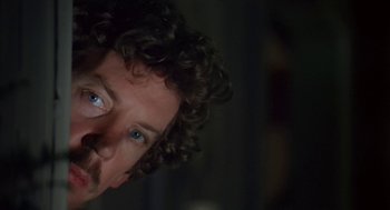 Movie still from “Invasion of the Body Snatchers” (1978), directed by Philip Kaufman – A person with blue eyes; Close Up shot, Over the shoulder angle