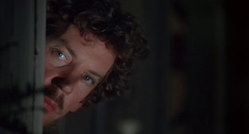 Movie still from “Invasion of the Body Snatchers” (1978), directed by Philip Kaufman – A person with blue eyes; Close Up shot, Over the shoulder angle