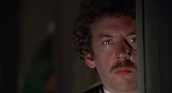 Movie still from “Invasion of the Body Snatchers” (1978), directed by Philip Kaufman – A person wearing a suit and tie; Close Up shot, Low angle