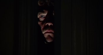 Movie still from “Invasion of the Body Snatchers” (1978), directed by Philip Kaufman – A man's face is lit up by the light from a window; Close Up shot, Low angle
