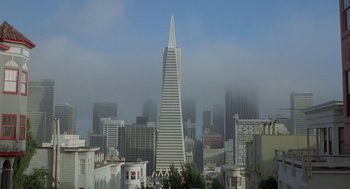 Movie still from “Invasion of the Body Snatchers” (1978), directed by Philip Kaufman – A view of a city skyline with a tall skyscraper in the background; Extreme Wide shot, Low angle