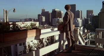 Movie still from “Invasion of the Body Snatchers” (1978), directed by Philip Kaufman – A man standing on a deck looking out at a city; Wide shot, Low angle