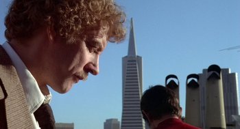 Movie still from “Invasion of the Body Snatchers” (1978), directed by Philip Kaufman – A person with a building in the background; Close Up shot, Low angle