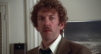 Movie still from “Invasion of the Body Snatchers” (1978), directed by Philip Kaufman – A person wearing a suit and tie; Close Up shot, Low angle
