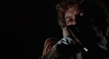 Movie still from “Invasion of the Body Snatchers” (1978), directed by Philip Kaufman – A man holding a cell phone up to his face; Close Up shot, Low angle