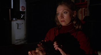 Movie still from “Invasion of the Body Snatchers” (1978), directed by Philip Kaufman – A woman in a red shirt is holding a black object; Close Up shot, Over the shoulder angle