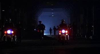 Movie still from “Invasion of the Body Snatchers” (1978), directed by Philip Kaufman – A group of people on a motorcycle at night; Extreme Wide shot, Low angle