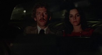 Movie still from “Invasion of the Body Snatchers” (1978), directed by Philip Kaufman – A man and a woman sitting in the back of a car; Close Up shot, Low angle