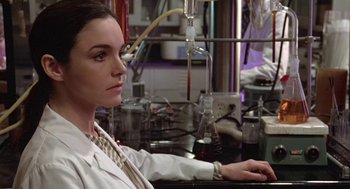 Movie still from “Invasion of the Body Snatchers” (1978), directed by Philip Kaufman – A woman sitting at a table in front of a microscope; Close Up shot, Low angle
