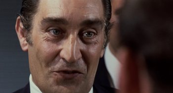 Movie still from “Investigation of a Citizen Above Suspicion” (1970), directed by Elio Petri – A man's eyes and face; Close Up shot, Over the shoulder angle