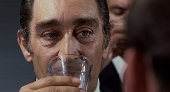 Movie still from “Investigation of a Citizen Above Suspicion” (1970), directed by Elio Petri – A person drinking a glass of water; Extreme Close Up shot, Over the shoulder angle