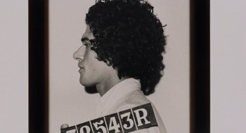 Movie still from “Investigation of a Citizen Above Suspicion” (1970), directed by Elio Petri – A black and white photo of a man in a prison outfit; Close Up shot, Low angle