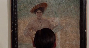 Movie still from “Investigation of a Citizen Above Suspicion” (1970), directed by Elio Petri – A woman with a hat is reflected in a mirror; Extreme Close Up shot, Overhead angle