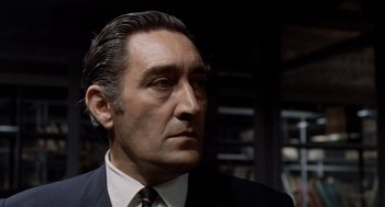 Movie still from “Investigation of a Citizen Above Suspicion” (1970), directed by Elio Petri – A person wearing a suit and tie; Close Up shot, Low angle